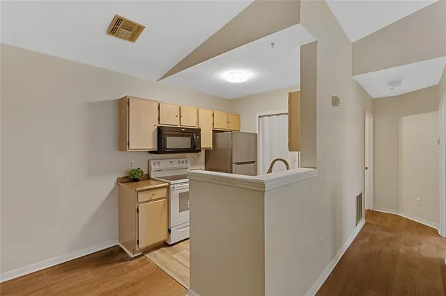 a view of a kitchen with refrigerator and microwave