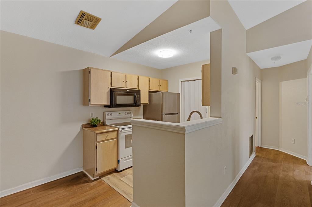 4360 South Kirkman Road, Unit 4 Orlando, FL 32811 - Photo 11 of 21 a view of a kitchen with refrigerator and microwave