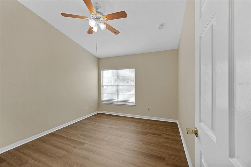 4360 South Kirkman Road, Unit 4 Orlando, FL 32811 - Photo 13 of 21 wooden floor in an empty room with a window