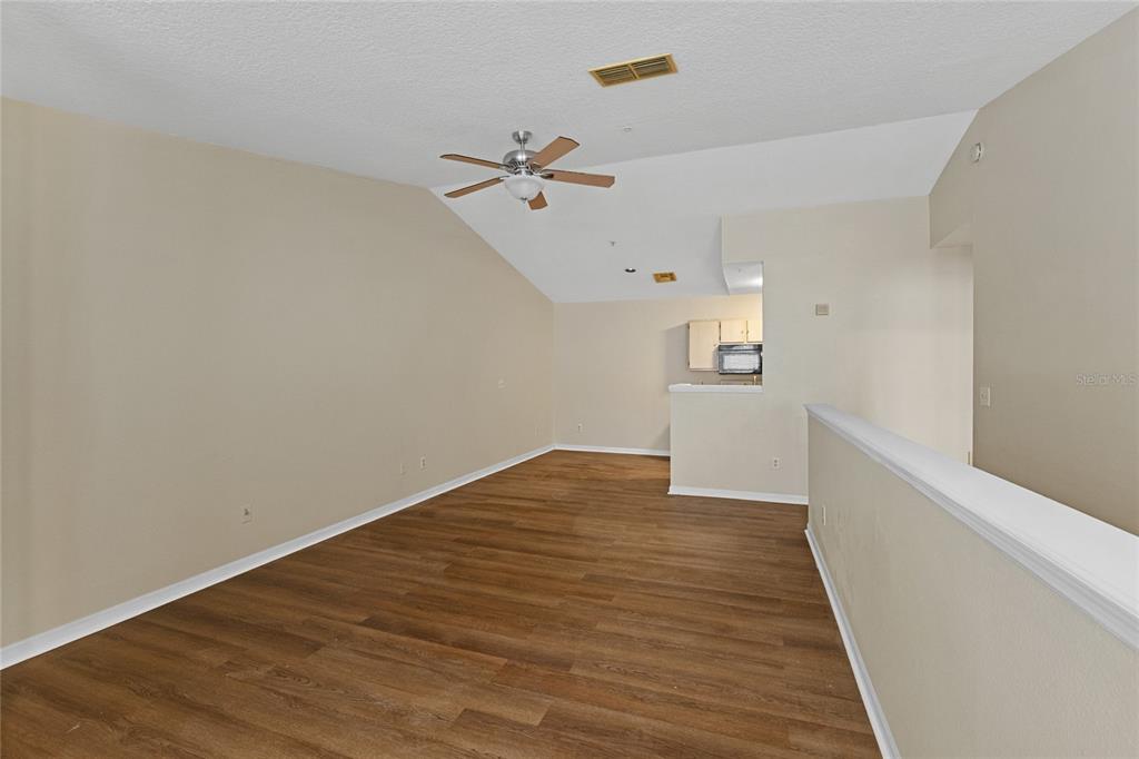 4360 South Kirkman Road, Unit 4 Orlando, FL 32811 - Photo 6 of 21 a view of empty room with wooden floor
