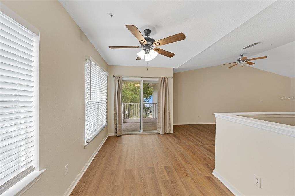 4360 South Kirkman Road, Unit 4 Orlando, FL 32811 - Photo 9 of 21 a view of an empty room with a window and wooden floor