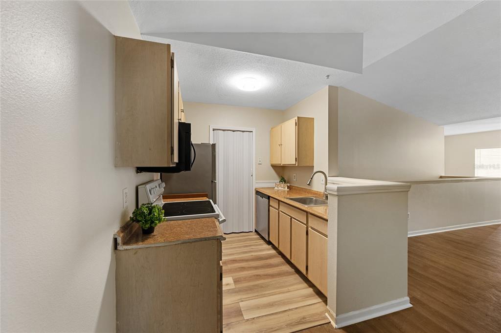 4360 South Kirkman Road, Unit 4 Orlando, FL 32811 - Photo 10 of 21 a kitchen with a sink and a stove top oven