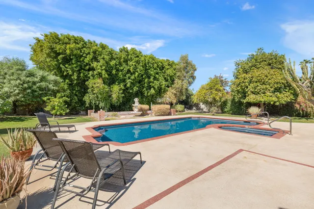 a view of a house with a yard and a garage