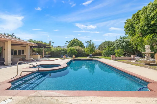 a view of a swimming pool with a lounge chair