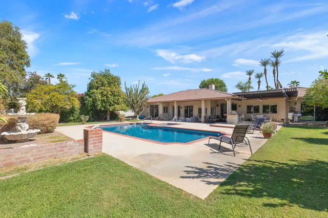 a view of a house with backyard porch and sitting area