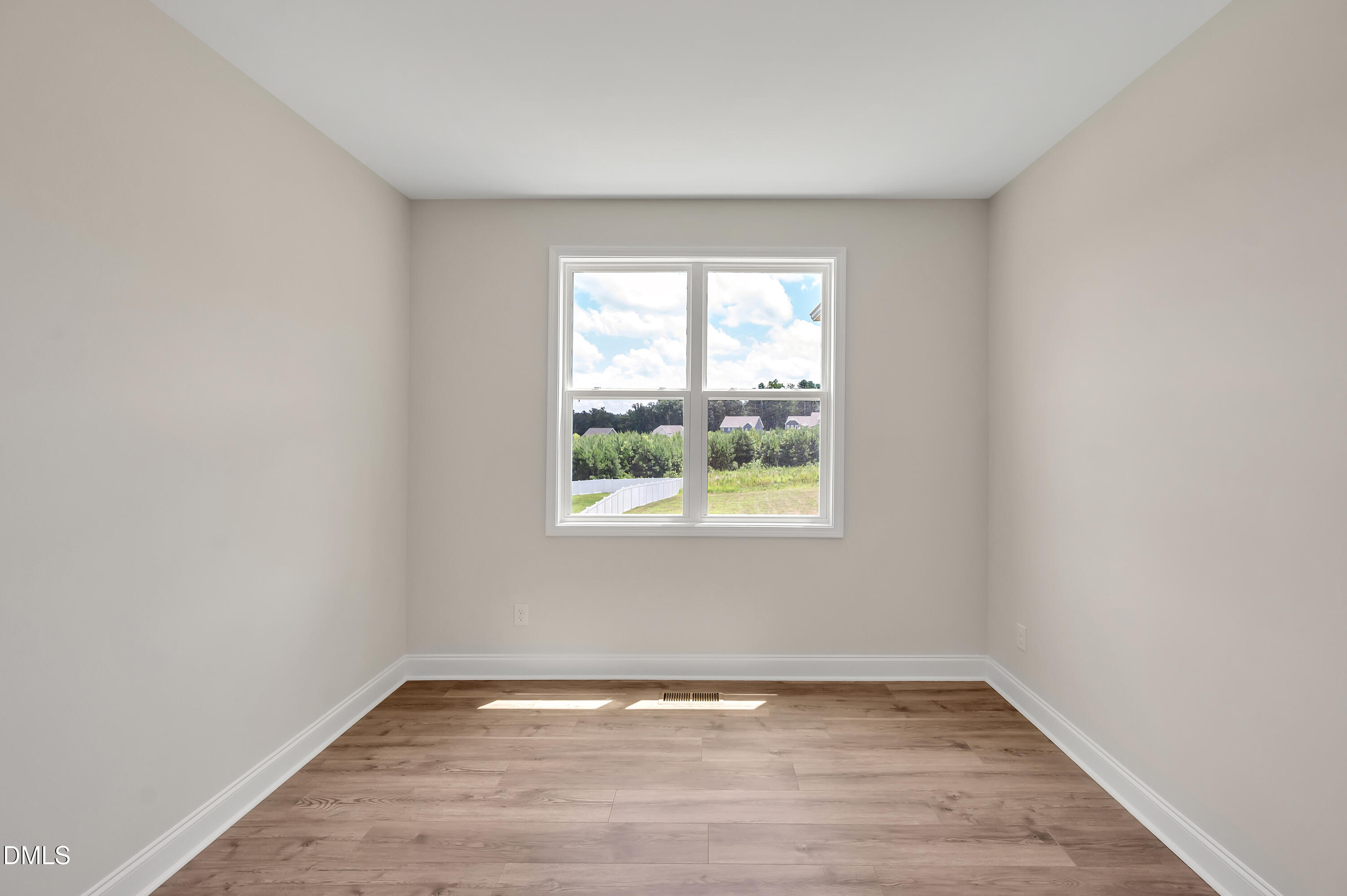 1108 Prominence Drive Durham, NC 27712 - Photo 9 of 27 a view of an empty room with wooden floor and a window