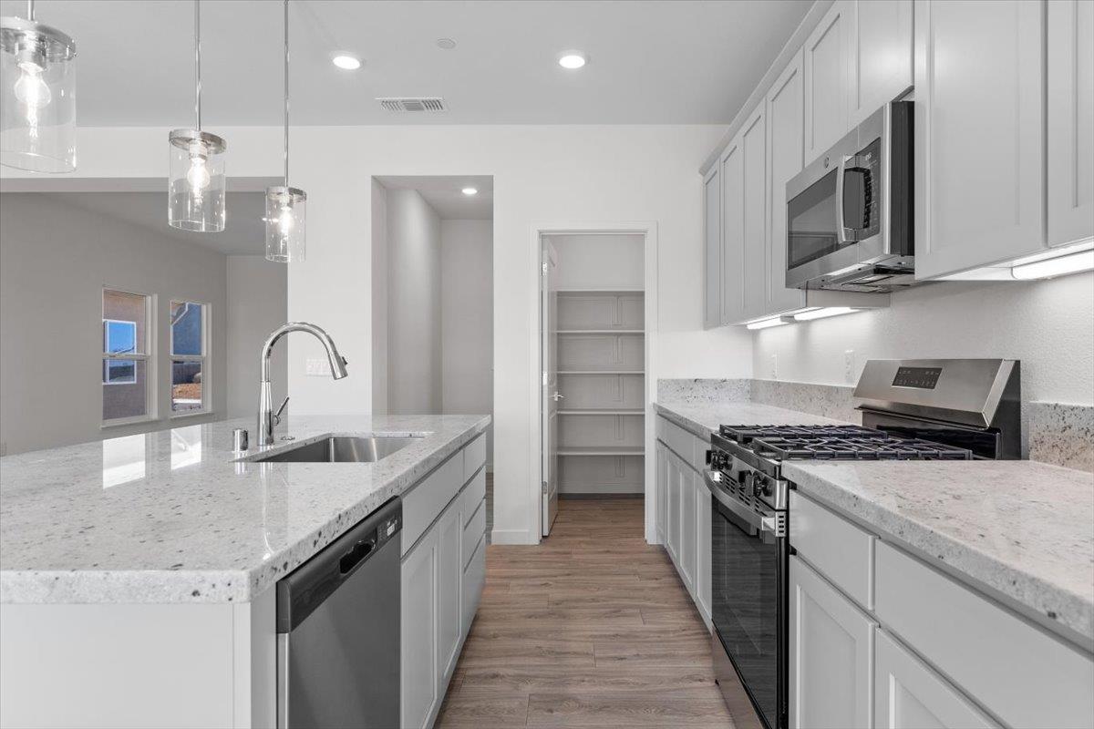 271 Piper Lane Colusa, CA 95932 - Photo 12 of 24 a kitchen with stainless steel appliances granite countertop a sink stove and refrigerator