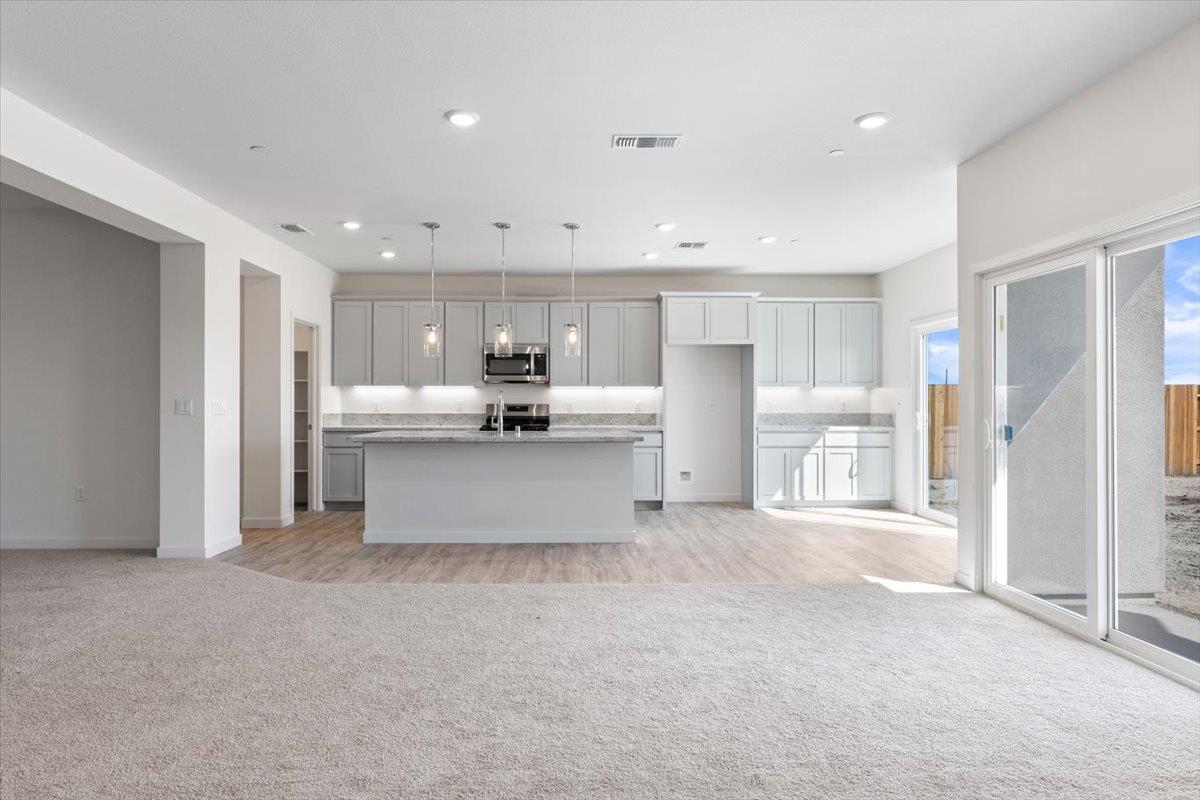 271 Piper Lane Colusa, CA 95932 - Photo 4 of 24 a kitchen with stainless steel appliances kitchen island sink refrigerator and cabinets