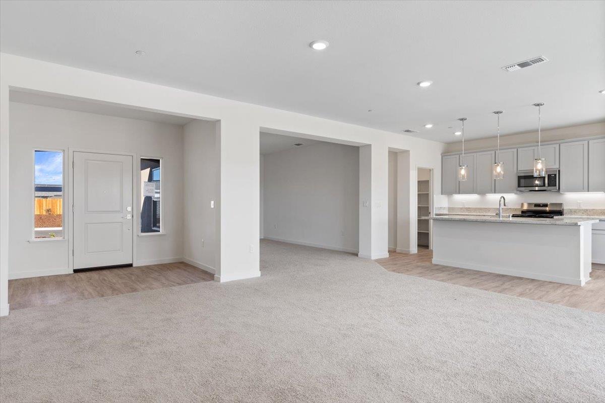 271 Piper Lane Colusa, CA 95932 - Photo 5 of 24 a view of a kitchen with refrigerator and white cabinets