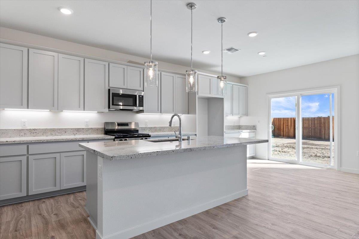 271 Piper Lane Colusa, CA 95932 - Photo 10 of 24 a kitchen with stainless steel appliances granite countertop a sink a stove top oven a counter space and cabinets