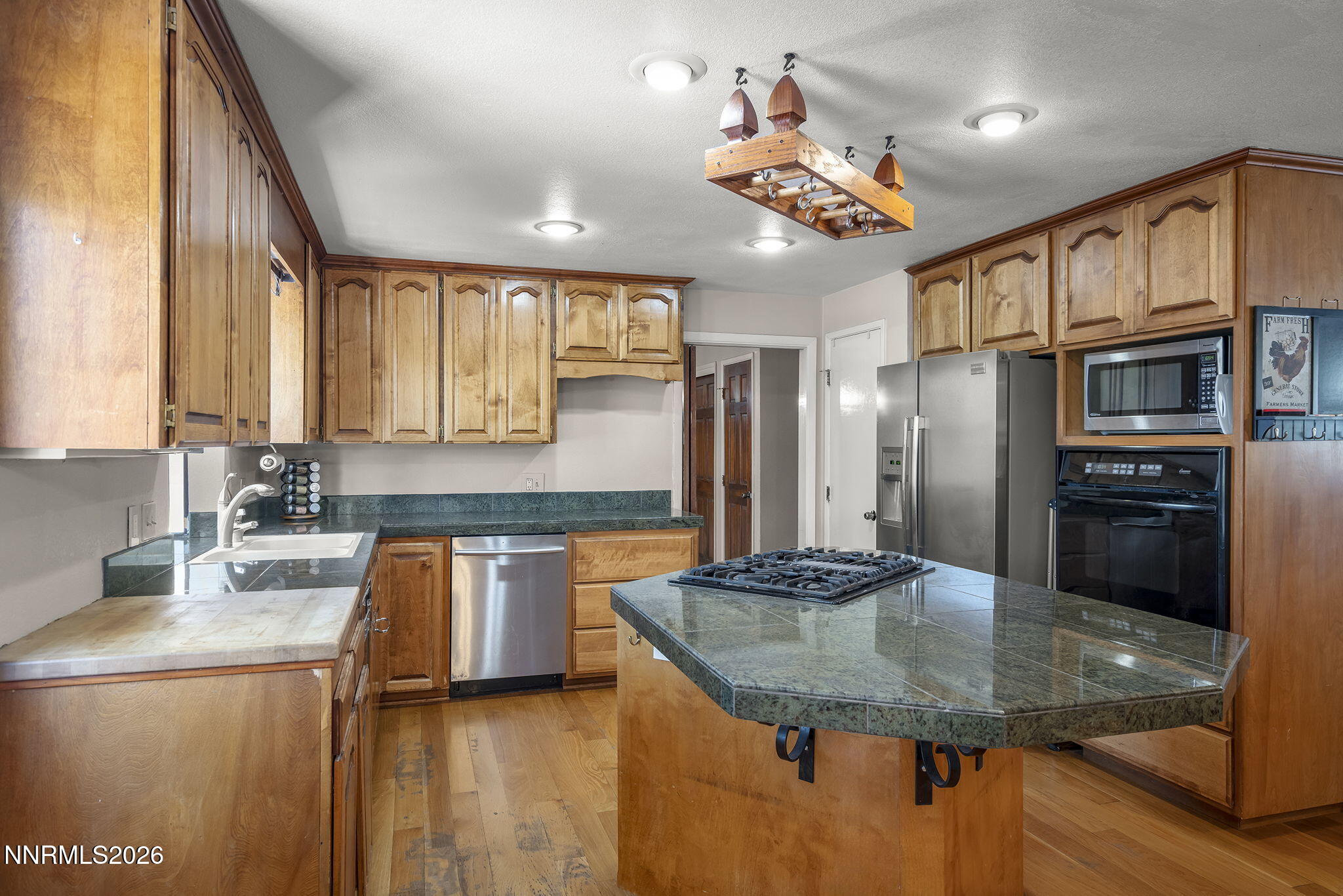 549 Ruby Lane Carson City, NV 89706 - Photo 8 of 37 a kitchen with stainless steel appliances granite countertop a sink refrigerator and cabinets