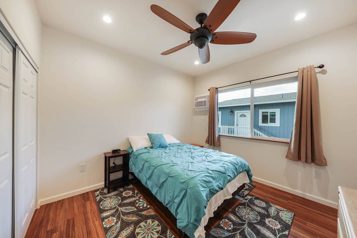 4598 Pueo Road, Unit B Kekaha, HI 96752 - Photo 12 of 27 a bedroom with a bed and a large window