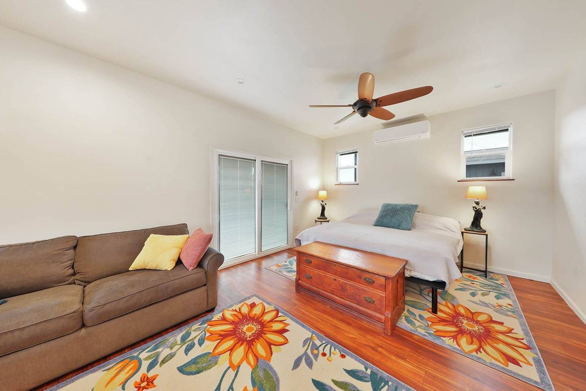 4598 Pueo Road, Unit B Kekaha, HI 96752 - Photo 16 of 27 a living room with furniture and a wooden floor