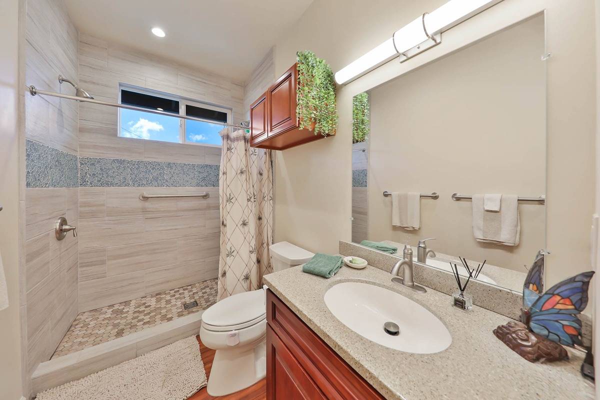 4598 Pueo Road, Unit B Kekaha, HI 96752 - Photo 18 of 27 a bathroom with a sink a toilet and shower