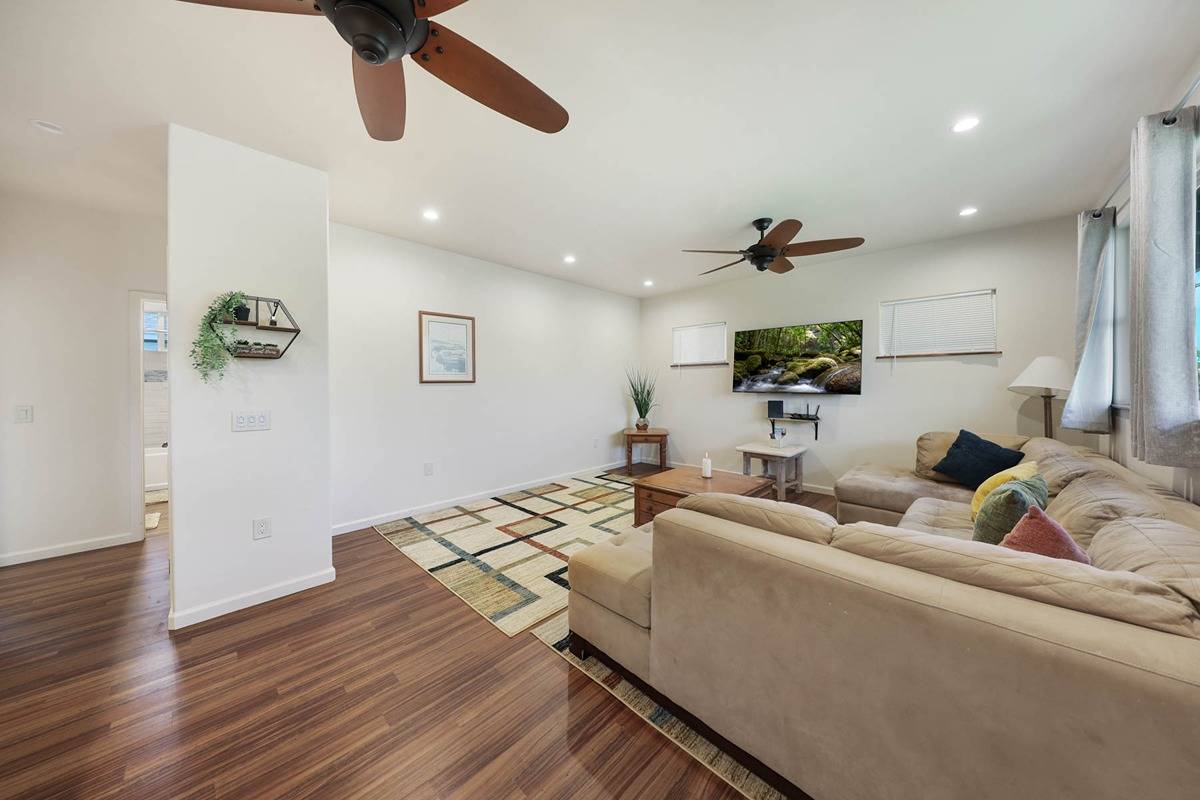 4598 Pueo Road, Unit B Kekaha, HI 96752 - Photo 3 of 27 a living room with furniture and a wooden floor