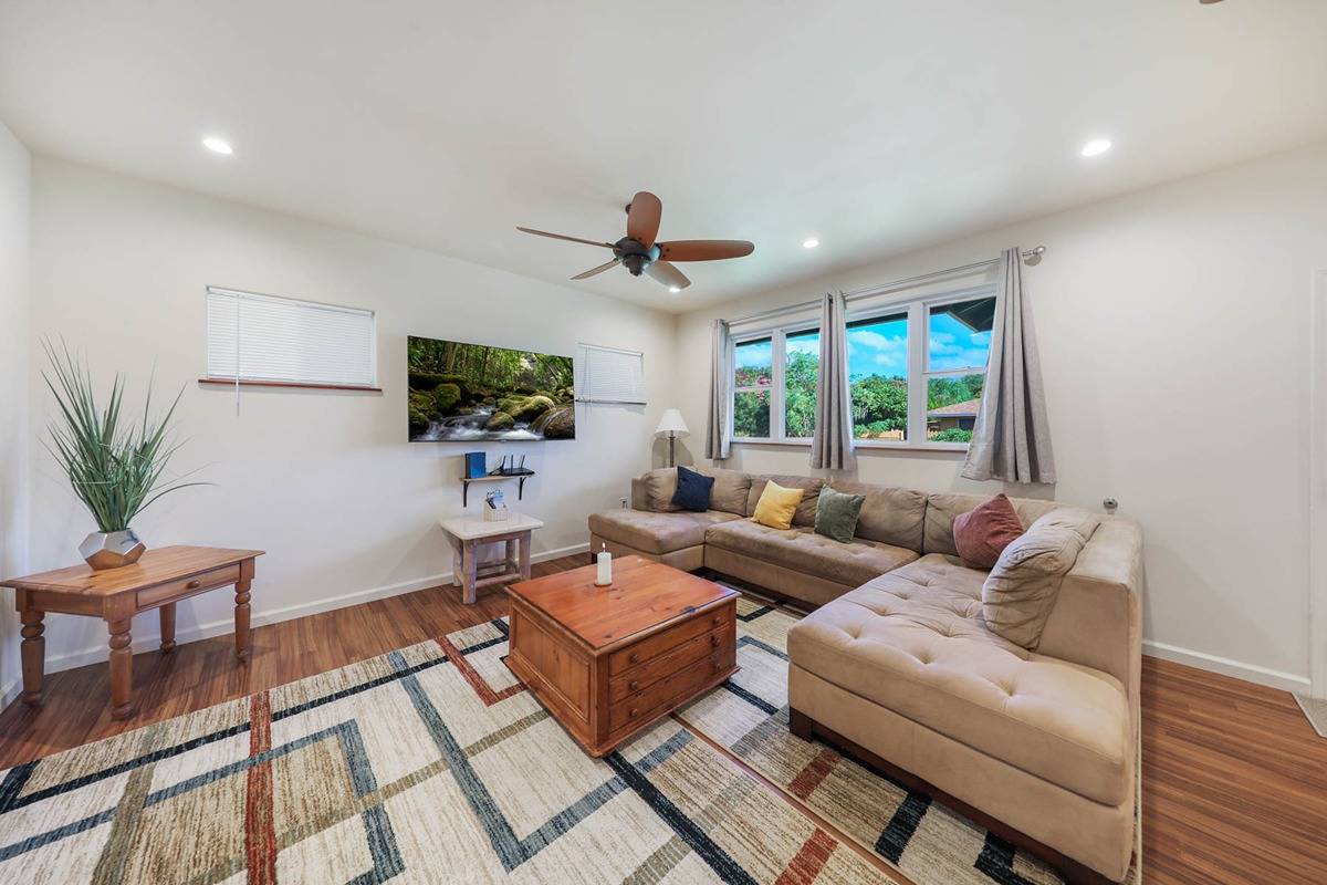 4598 Pueo Road, Unit B Kekaha, HI 96752 - Photo 4 of 27 a living room with furniture a chandelier and a flat screen tv