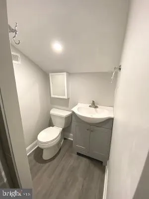 a bathroom with a sink toilet and a mirror