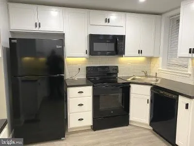 a kitchen with a refrigerator and a stove