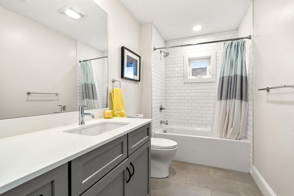 130 Coleridge Street, Unit 6 Boston, MA 02128 - Photo 6 of 26 a bathroom with a granite countertop sink toilet and shower