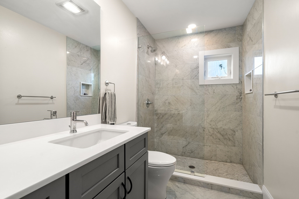130 Coleridge Street, Unit 6 Boston, MA 02128 - Photo 7 of 26 a bathroom with a sink a toilet and shower