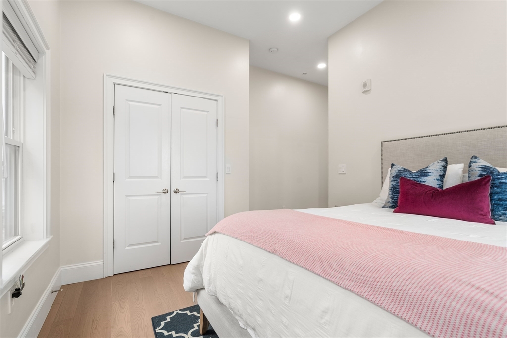 130 Coleridge Street, Unit 6 Boston, MA 02128 - Photo 8 of 26 a bedroom with a bed and a window