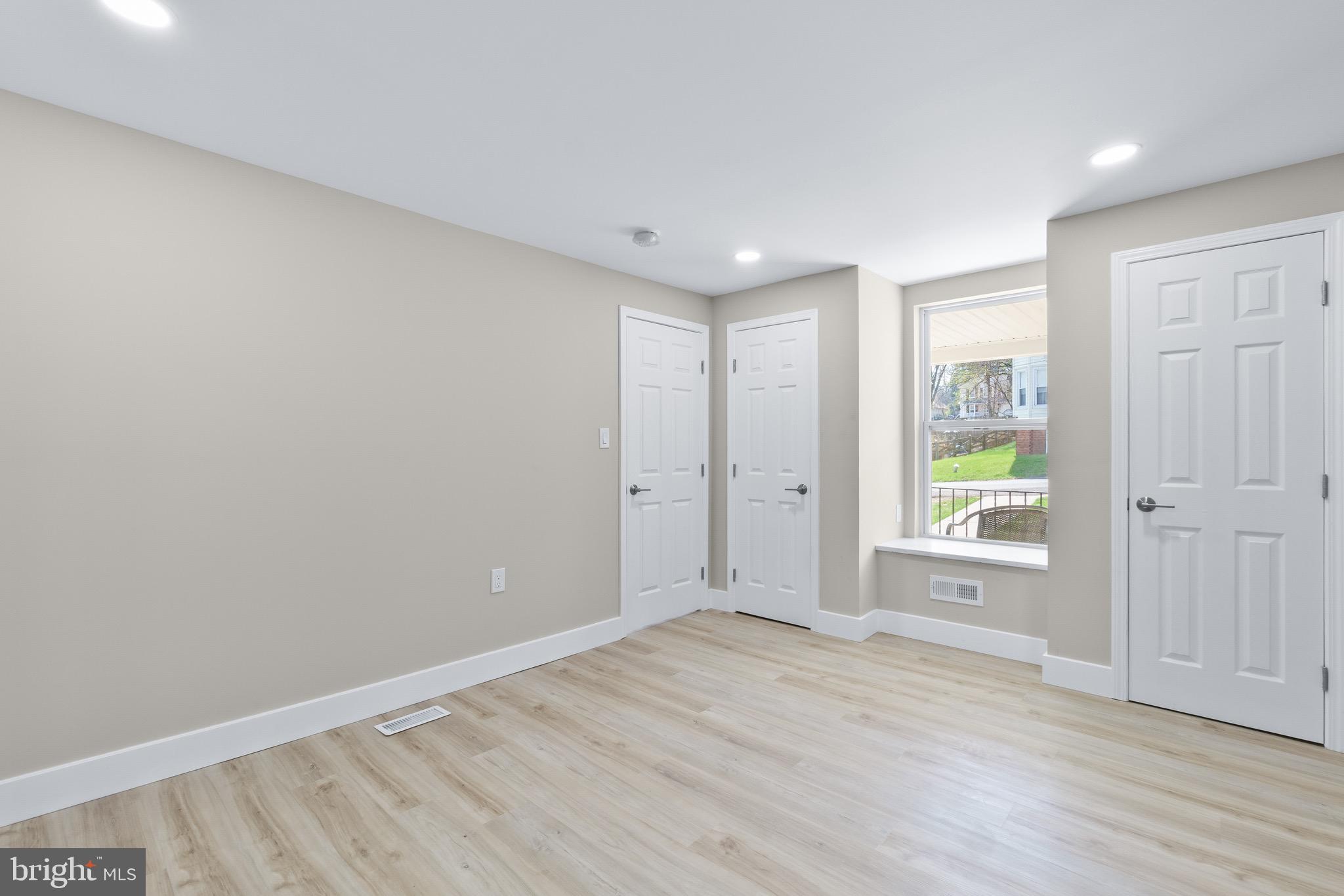 11 Baker Street Mount Airy, MD 21771 - Photo 12 of 30 an empty room with wooden floor and windows