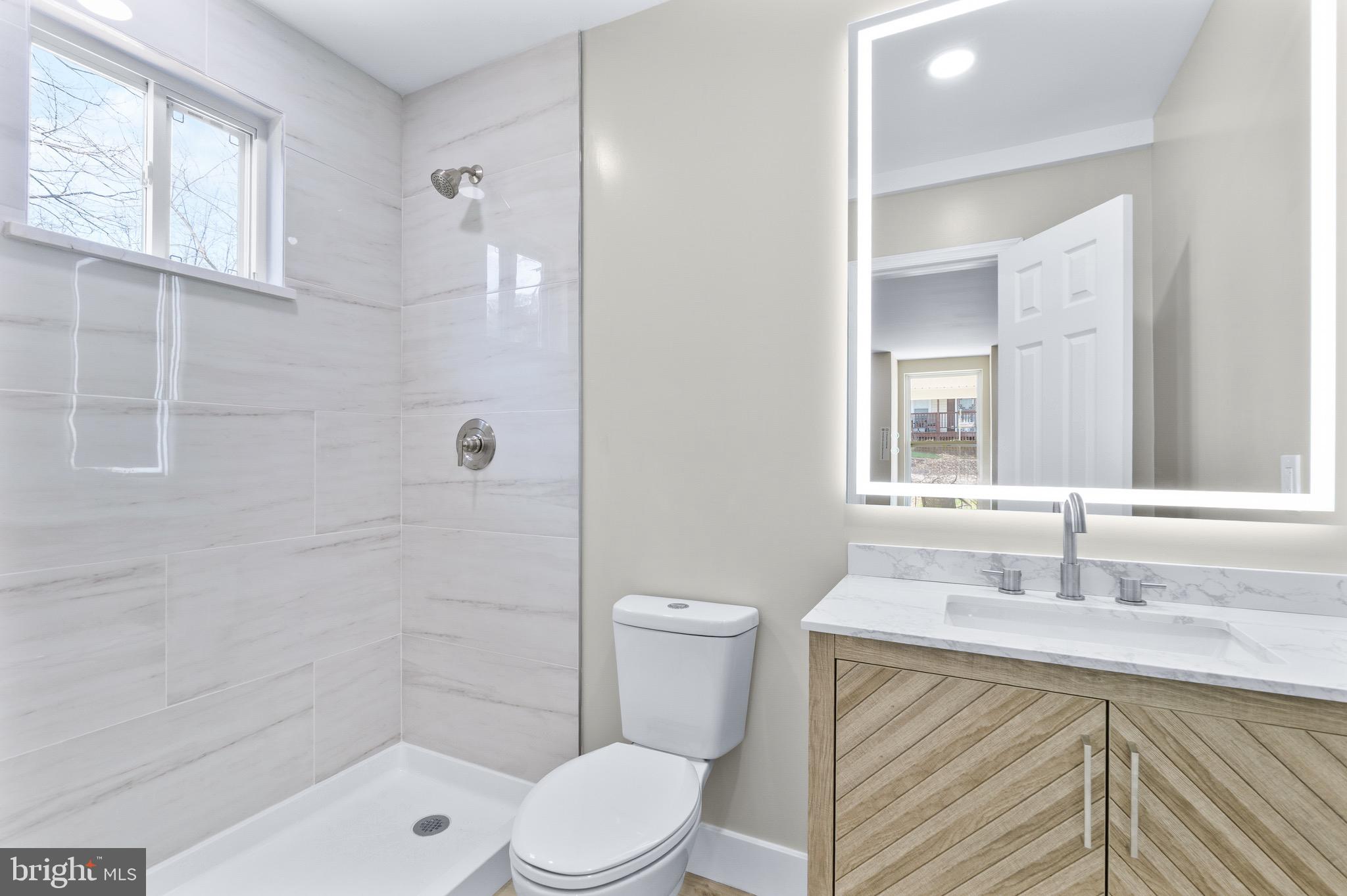 11 Baker Street Mount Airy, MD 21771 - Photo 13 of 30 a bathroom with a sink a toilet and shower