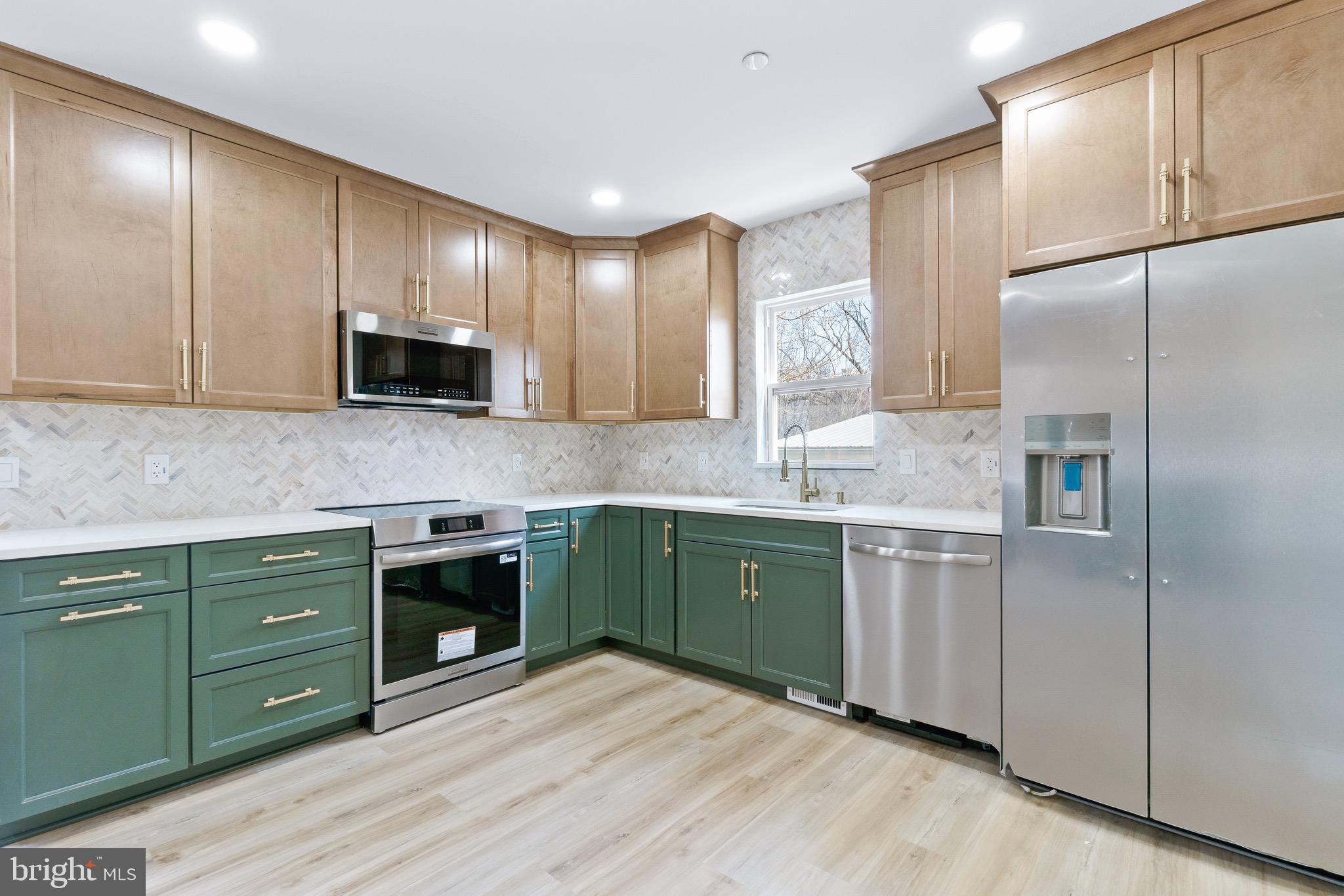 11 Baker Street Mount Airy, MD 21771 - Photo 14 of 30 a kitchen with stainless steel appliances granite countertop a sink a stove a refrigerator and cabinets