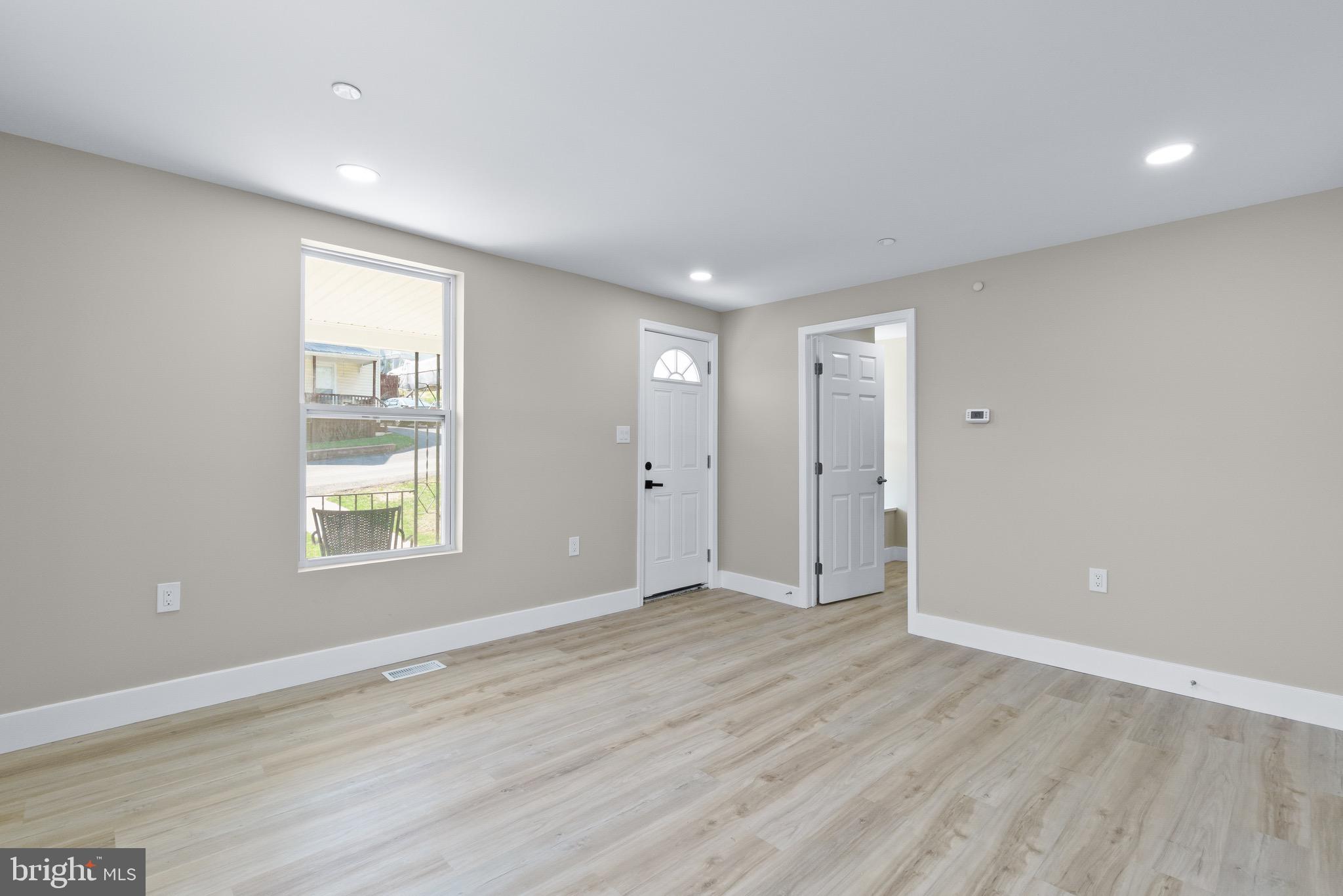 11 Baker Street Mount Airy, MD 21771 - Photo 24 of 30 a view of an empty room with wooden floor and a window