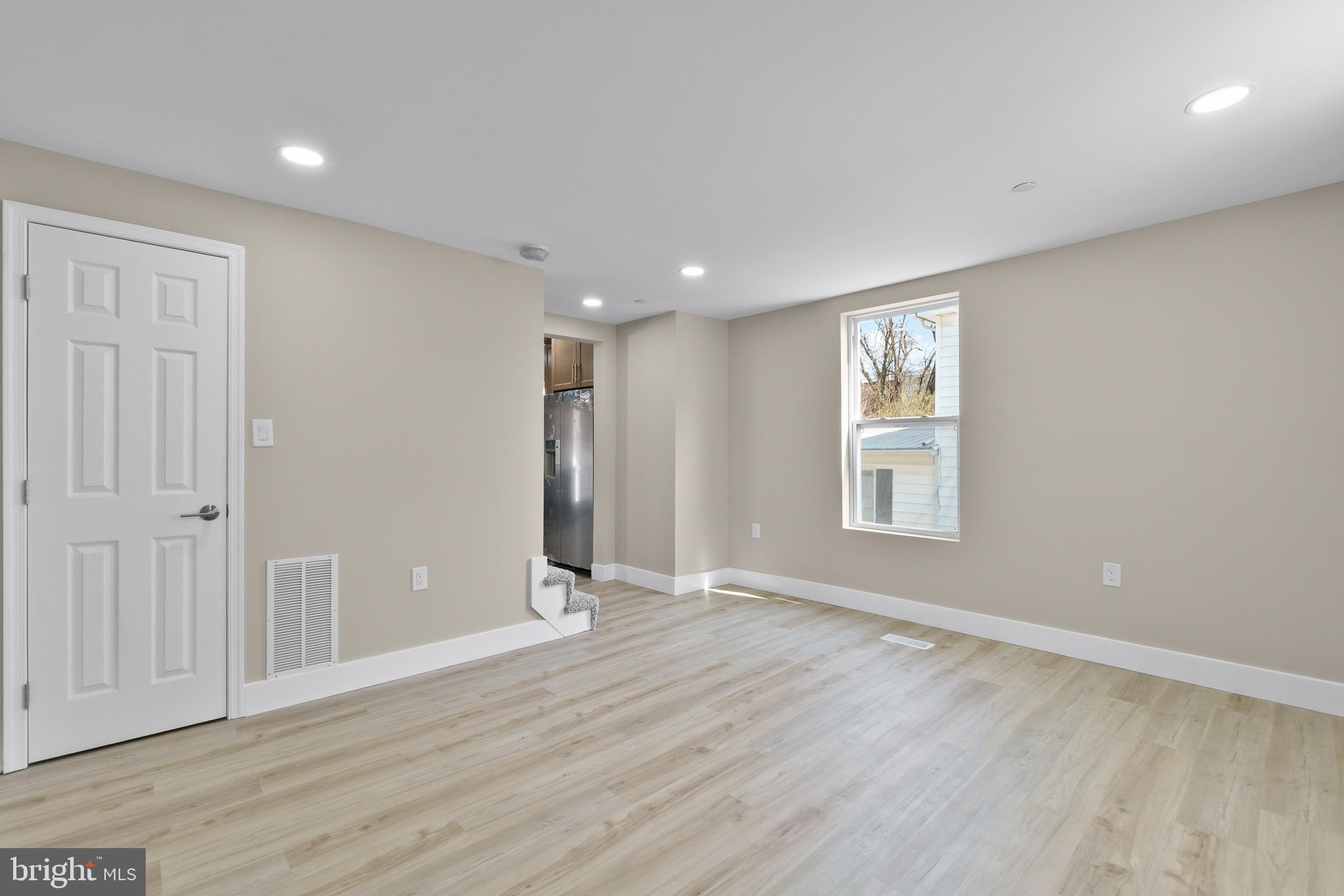 11 Baker Street Mount Airy, MD 21771 - Photo 29 of 30 an empty room with wooden floor and windows