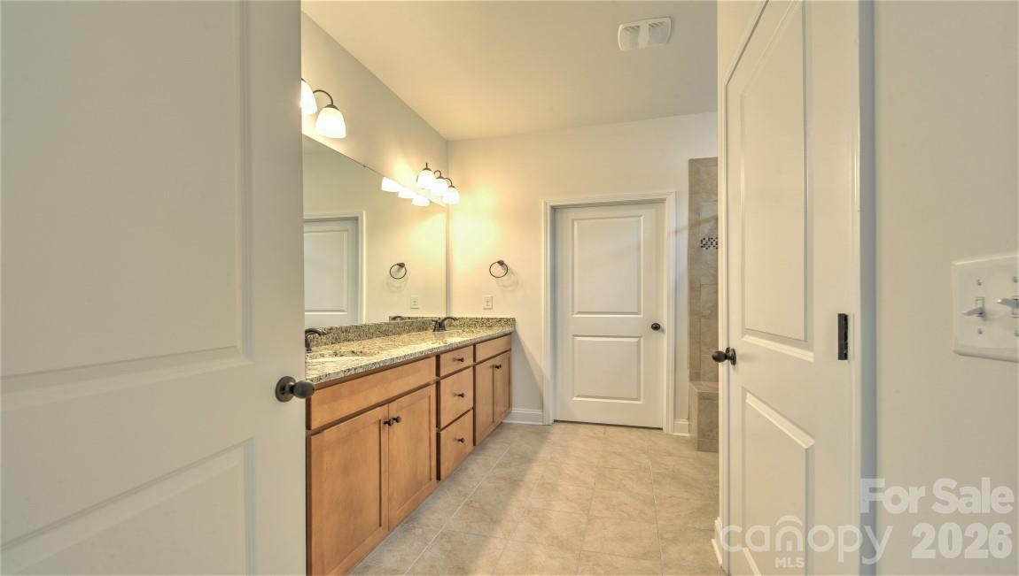 649 River Btm Road Fletcher, NC 28732 - Photo 29 of 40 a bathroom with a granite countertop sink and a mirror