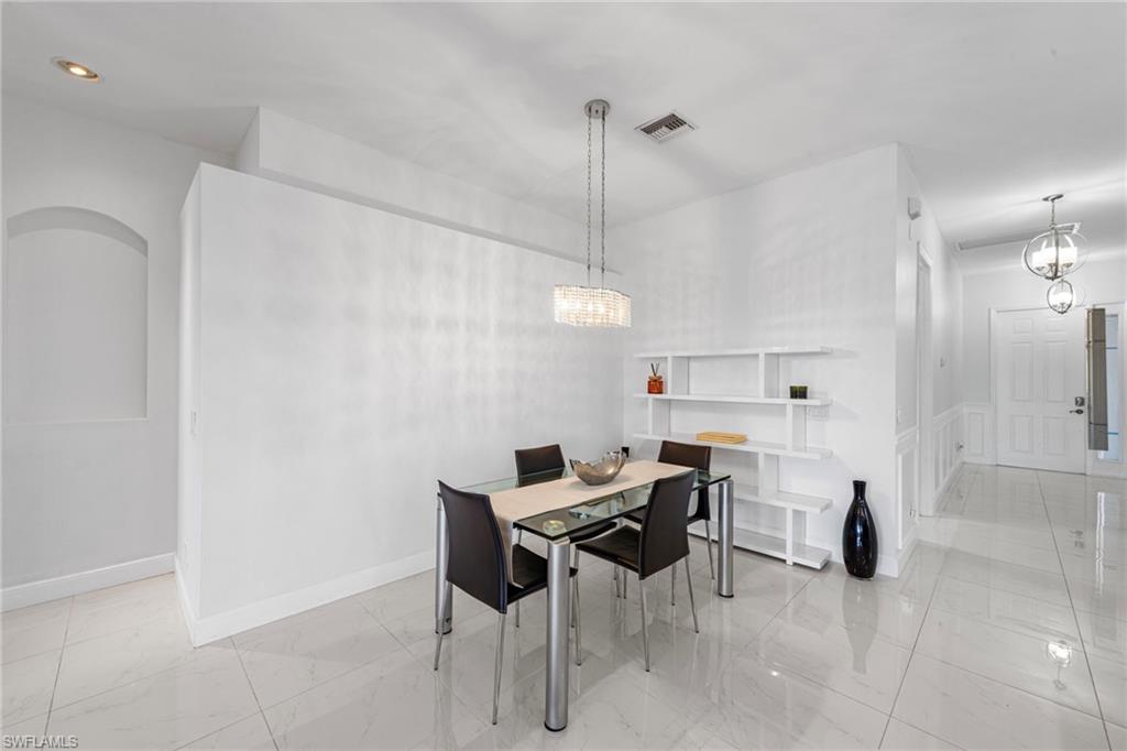 21550 Berwhich Run Estero, FL 33928 - Photo 12 of 50 a view of a dining room with furniture