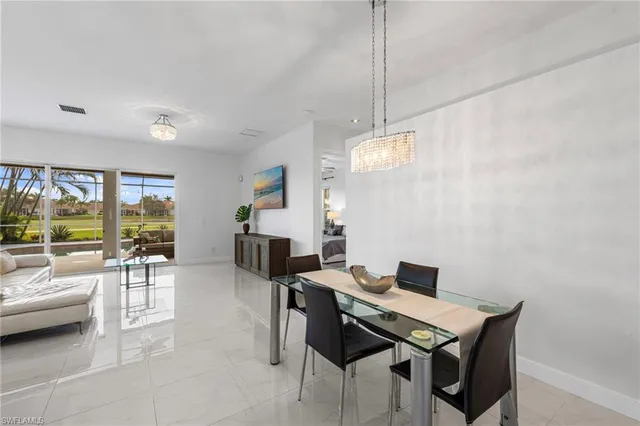 a view of a livingroom with furniture and a floor to ceiling window