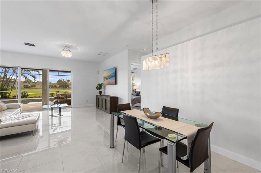 21550 Berwhich Run Estero, FL 33928 - Photo 13 of 50 a view of a livingroom with furniture and a floor to ceiling window