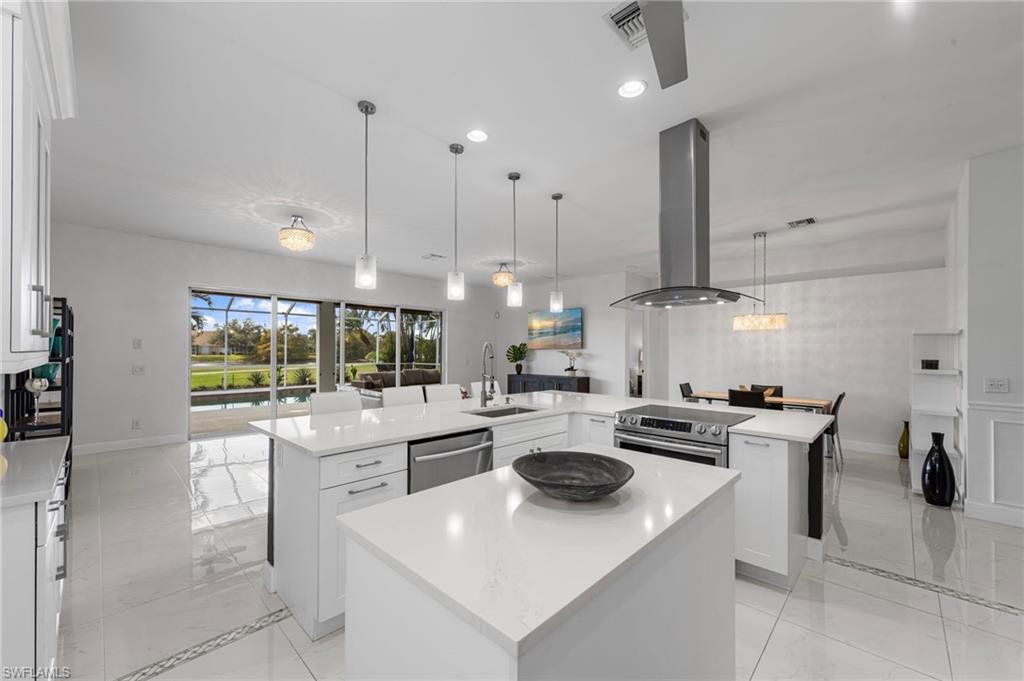 21550 Berwhich Run Estero, FL 33928 - Photo 16 of 50 a kitchen with a stove a refrigerator and a fireplace