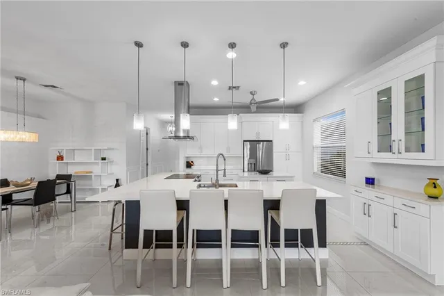 a large kitchen with a table and chairs