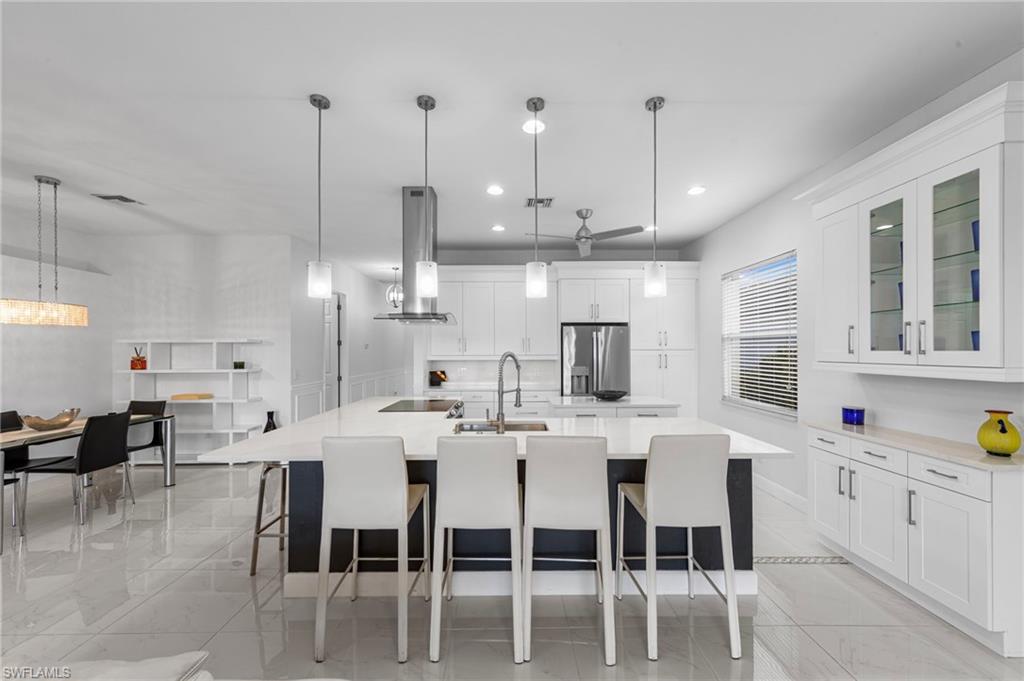 21550 Berwhich Run Estero, FL 33928 - Photo 19 of 50 a large kitchen with a table and chairs