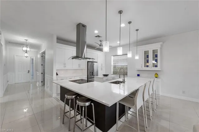 a kitchen with a table chairs refrigerator and microwave