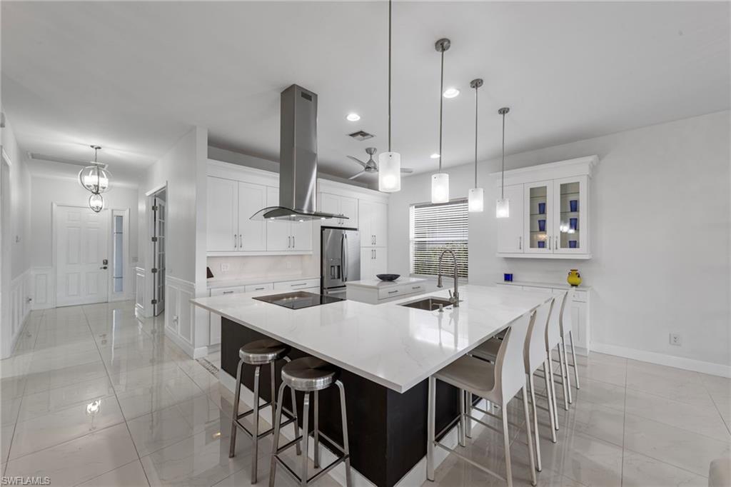 21550 Berwhich Run Estero, FL 33928 - Photo 20 of 50 a kitchen with a table chairs refrigerator and microwave