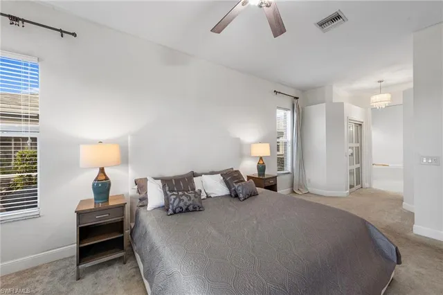 a bedroom with a bed and a lamp