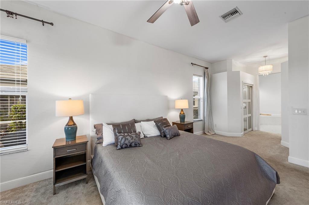 21550 Berwhich Run Estero, FL 33928 - Photo 22 of 50 a bedroom with a bed and a lamp