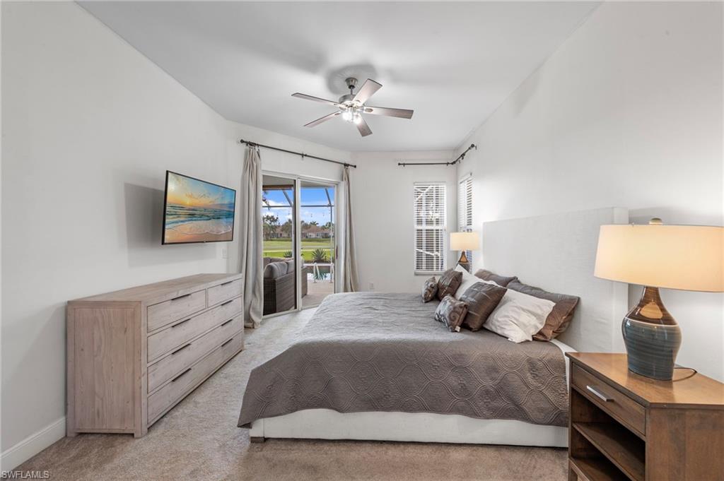 21550 Berwhich Run Estero, FL 33928 - Photo 23 of 50 a bedroom with a bed and a flat screen tv