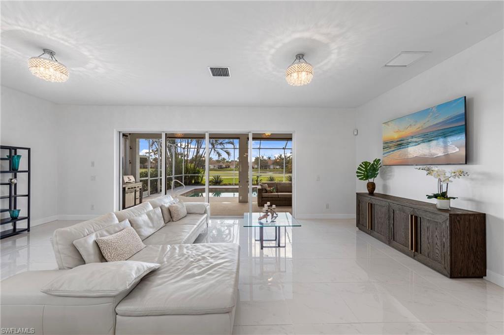 21550 Berwhich Run Estero, FL 33928 - Photo 3 of 50 a living room with furniture and a large window