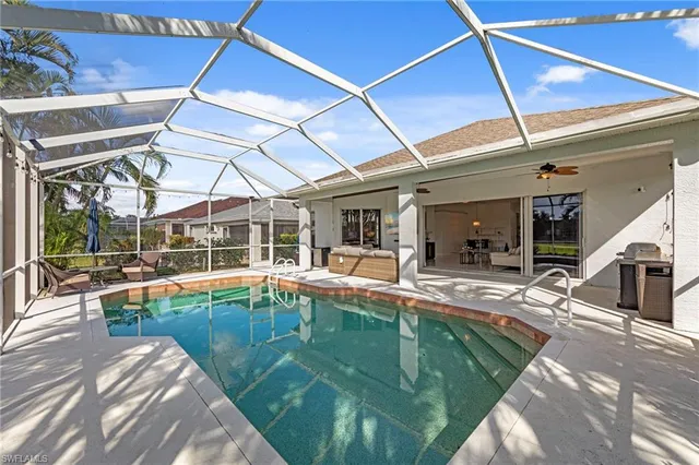 a view of a backyard with swimming pool