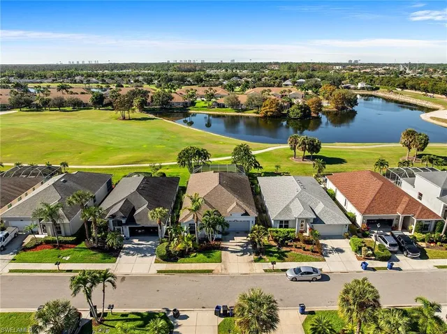 an aerial view of residential houses with outdoor space