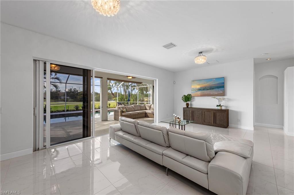 21550 Berwhich Run Estero, FL 33928 - Photo 5 of 50 a living room with furniture and a large window