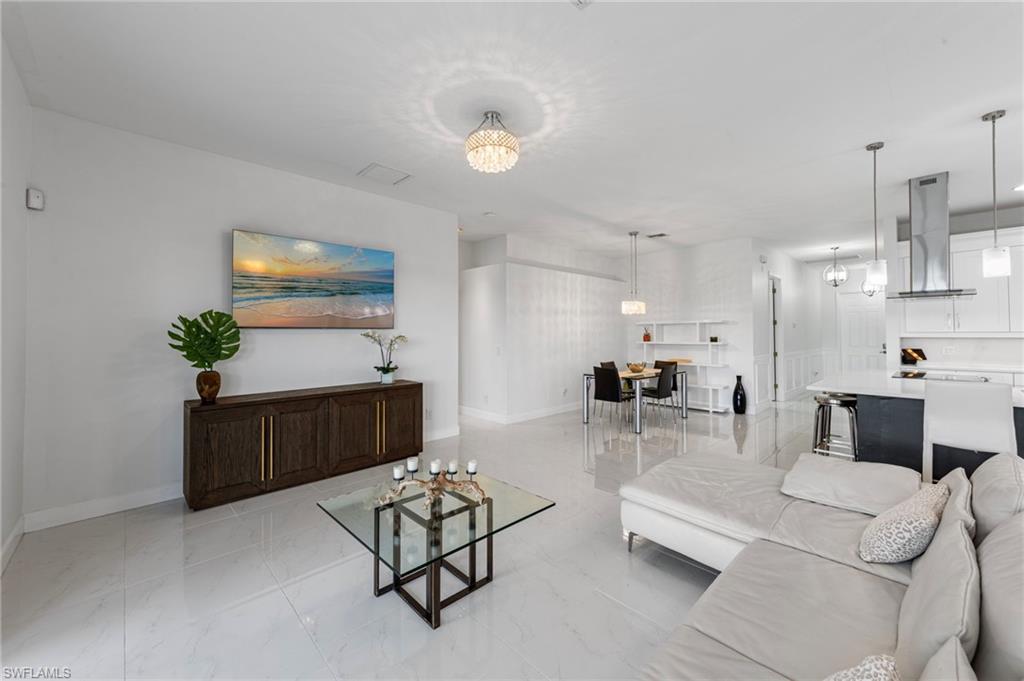 21550 Berwhich Run Estero, FL 33928 - Photo 8 of 50 a living room with furniture and a chandelier