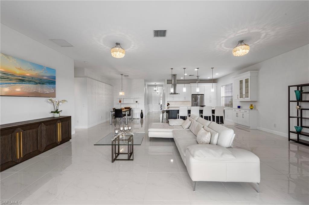 21550 Berwhich Run Estero, FL 33928 - Photo 9 of 50 a living room with furniture and a refrigerator