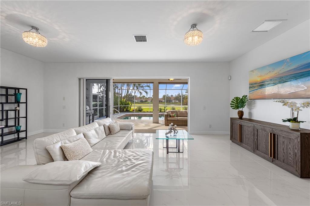 21550 Berwhich Run Estero, FL 33928 - Photo 10 of 50 a living room with furniture and a large window