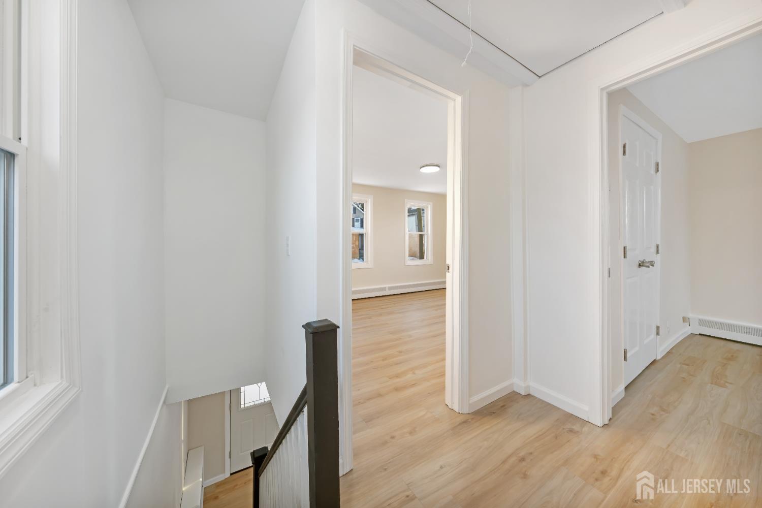 25 Dane Street Sayreville, NJ 08872 - Photo 11 of 31 a view of a hallway with wooden floor and staircase
